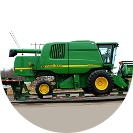 48 hours or Less John Deere Cotton Picker on a trailer